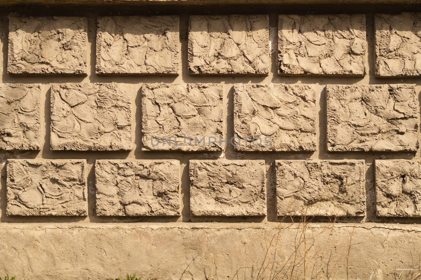 Old brick wall background. wall from squared bricks. cracked stone wall texture