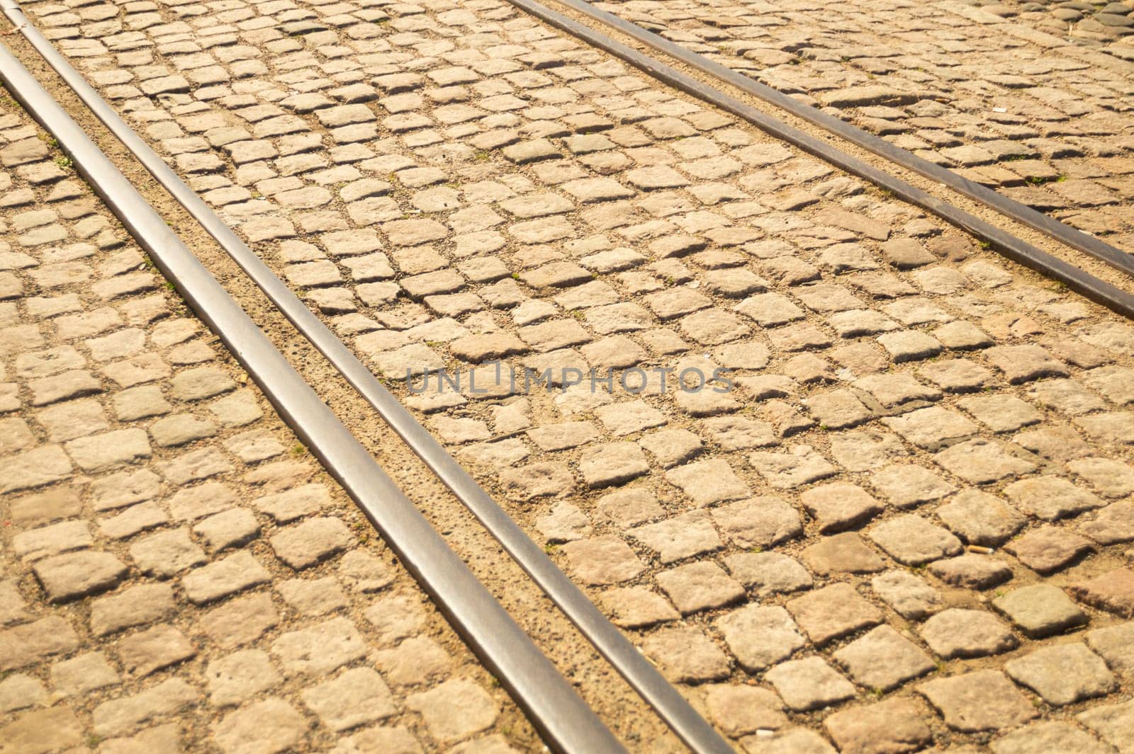 Brick texture. tram rails on stone pavement background