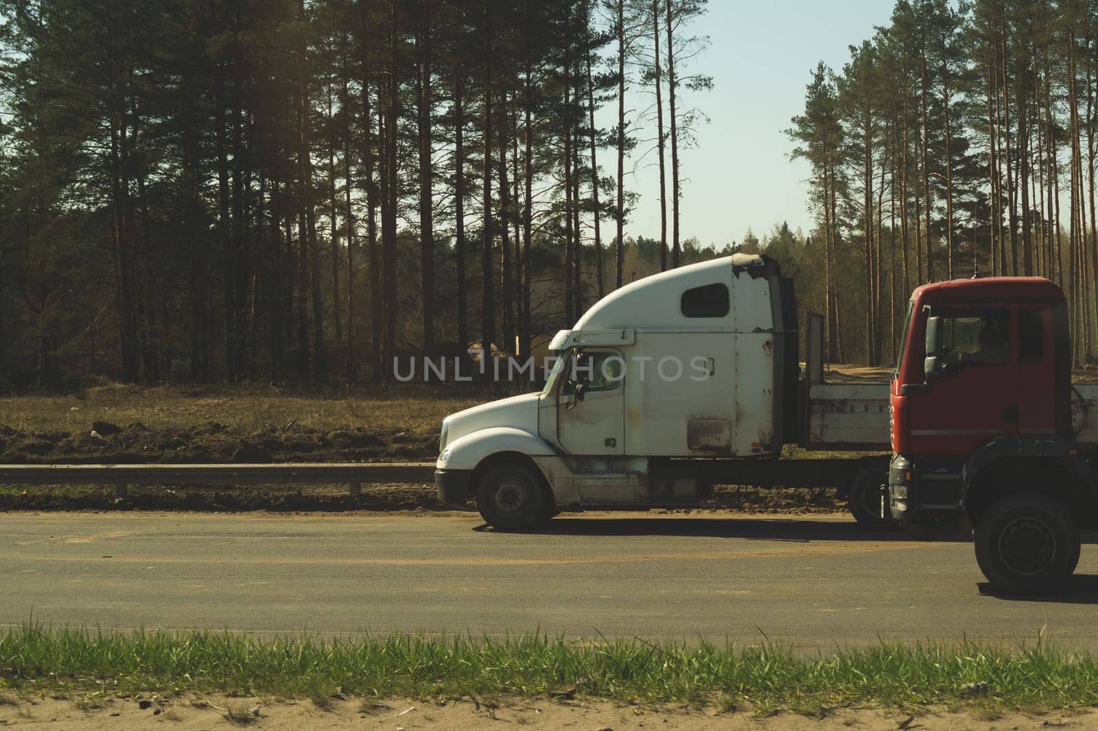 Big truck on the roadside near forest. white lorry on a road. transport vehicle