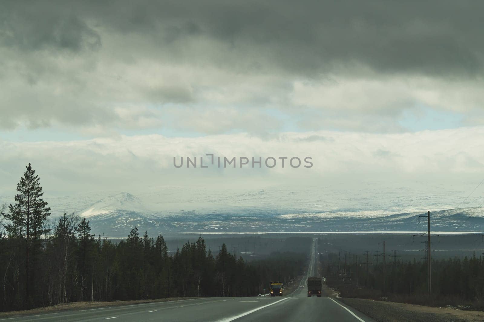 Beautiful mountain landscape with long roadway. winter highway. car driving on a mountain road. horizon line