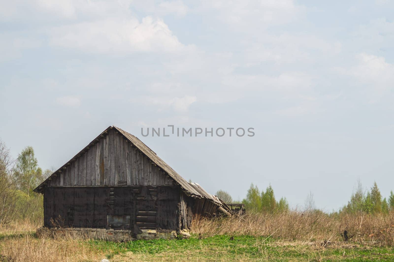 Old wooden house on the countryside. house standing alone among the field