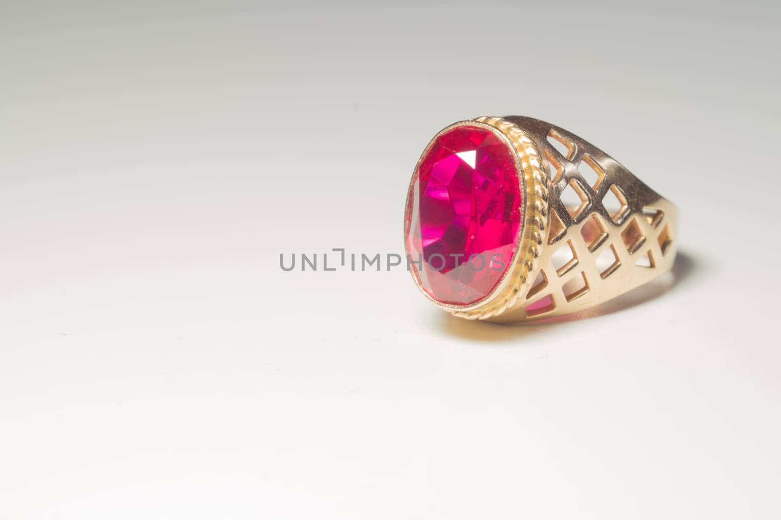 Golden ring with ruby isolated on white background