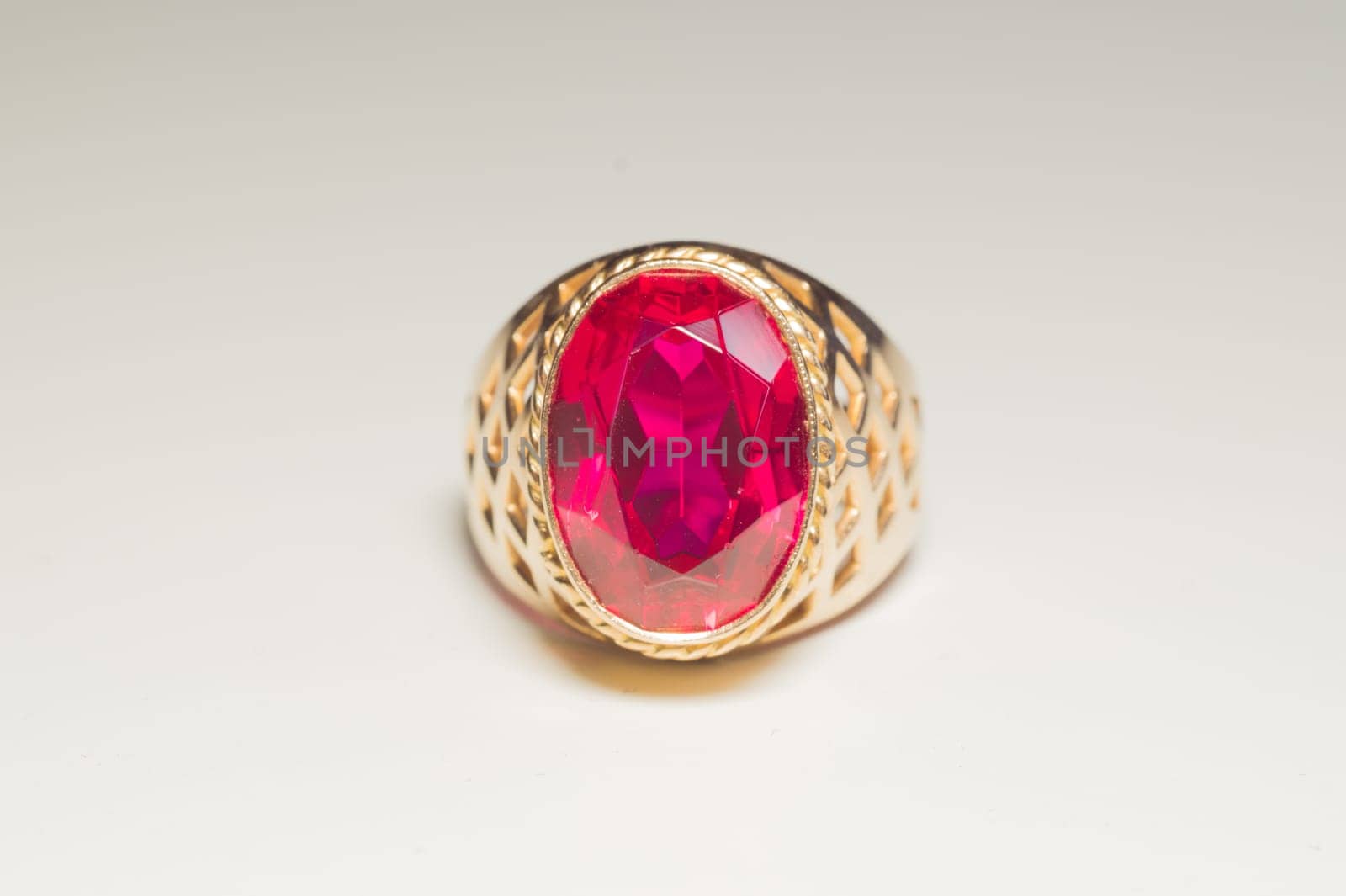 Golden ring with ruby isolated on white background