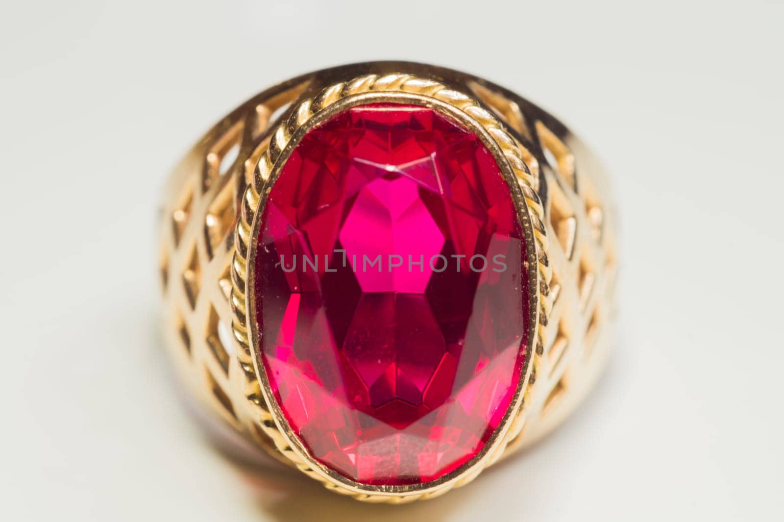 Golden ring with ruby isolated on white background