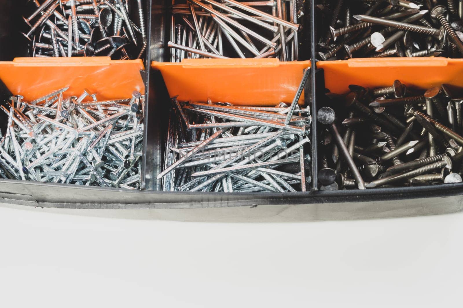 Various metal nails in toolbox background. nails in the cells of the box. copy space