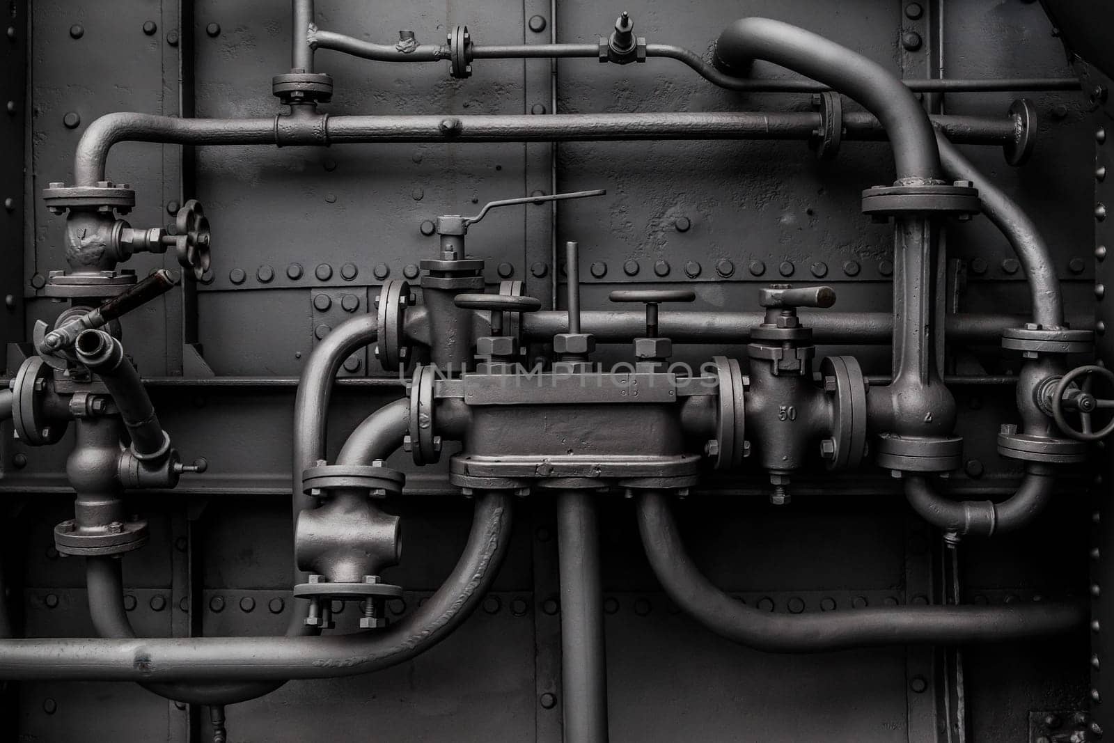 Industrial pipes and pressure valves as a background.