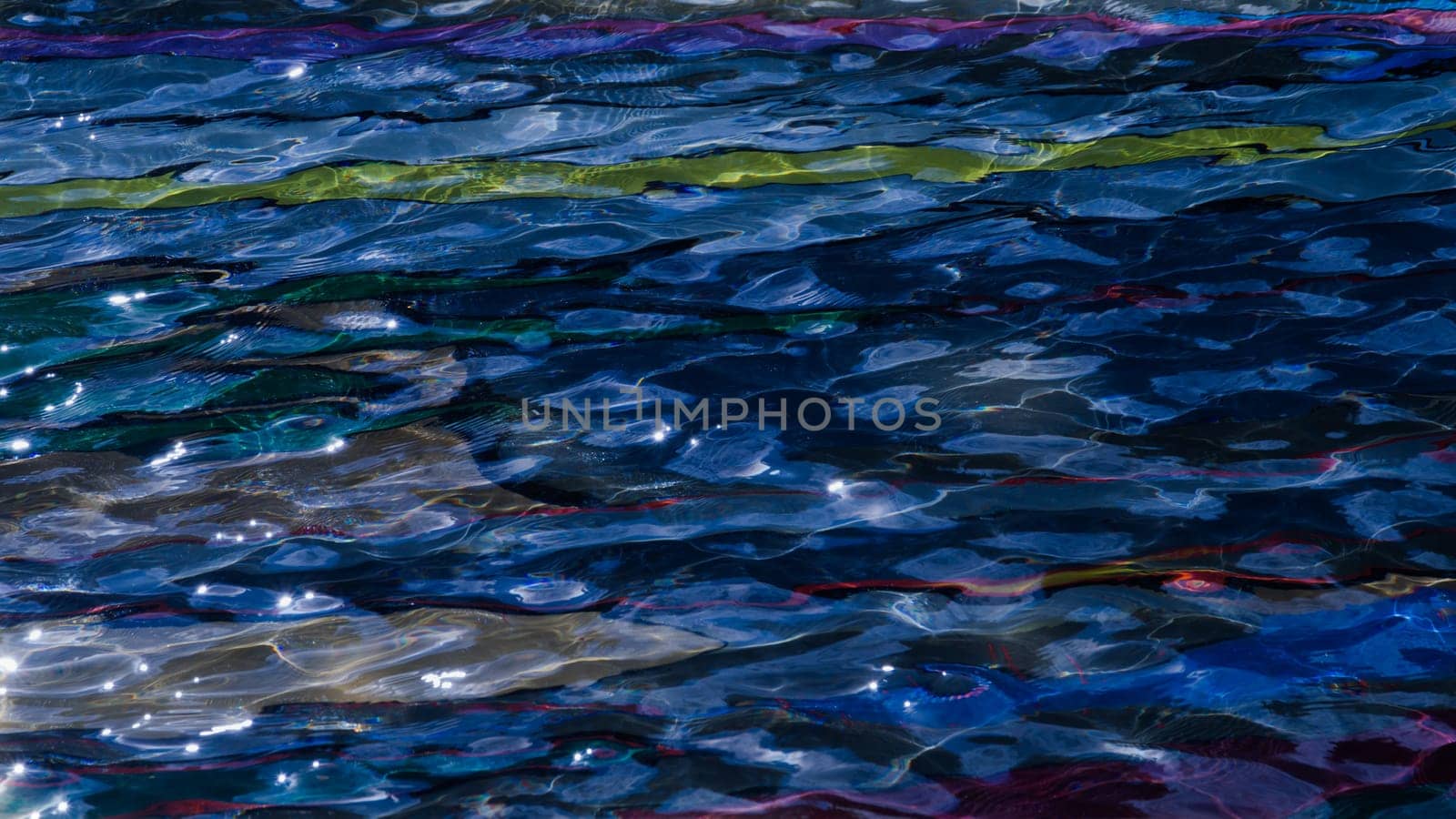 colorful pool water abstract background. colored bottom of the pool with rippled water