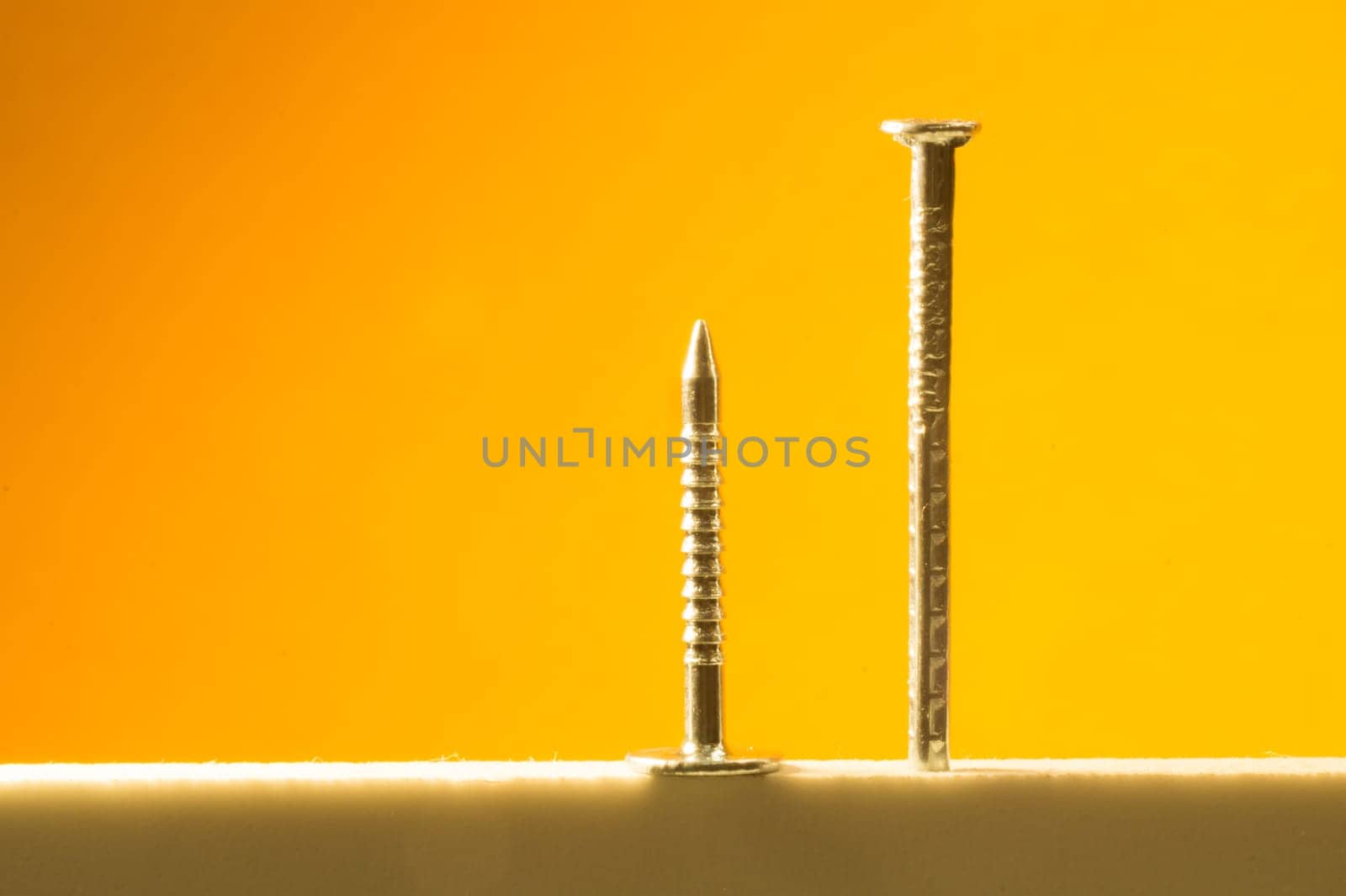 Metal nails isolated on yellow background