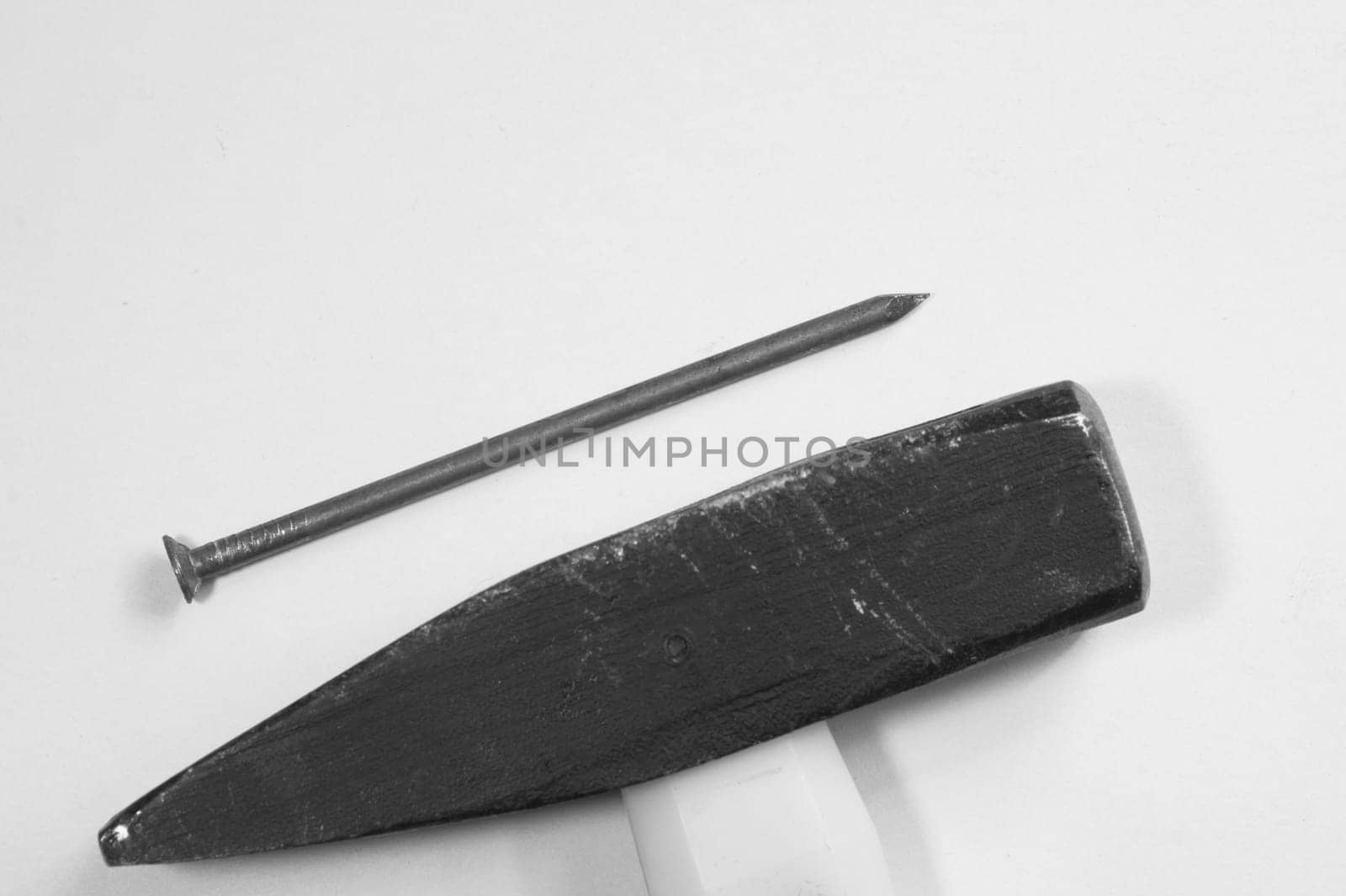 Hammer with a metal nail isolated on white background