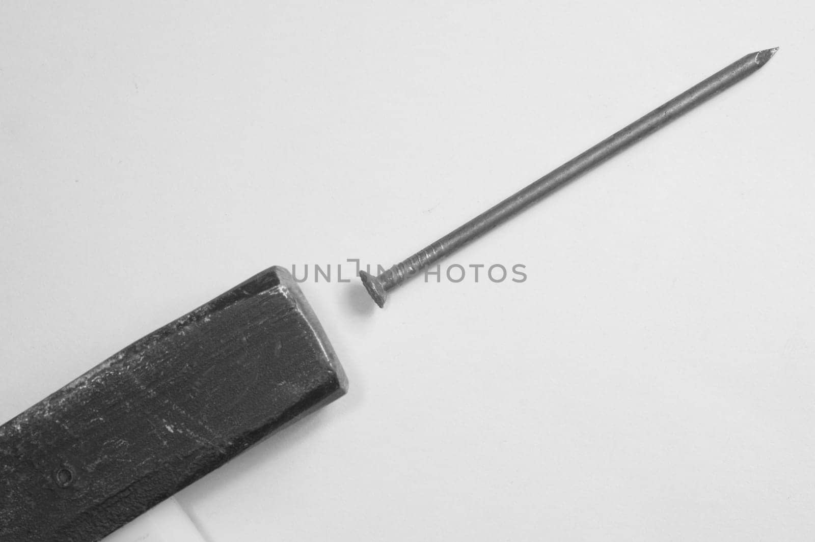 Hammer with a metal nail isolated on white background