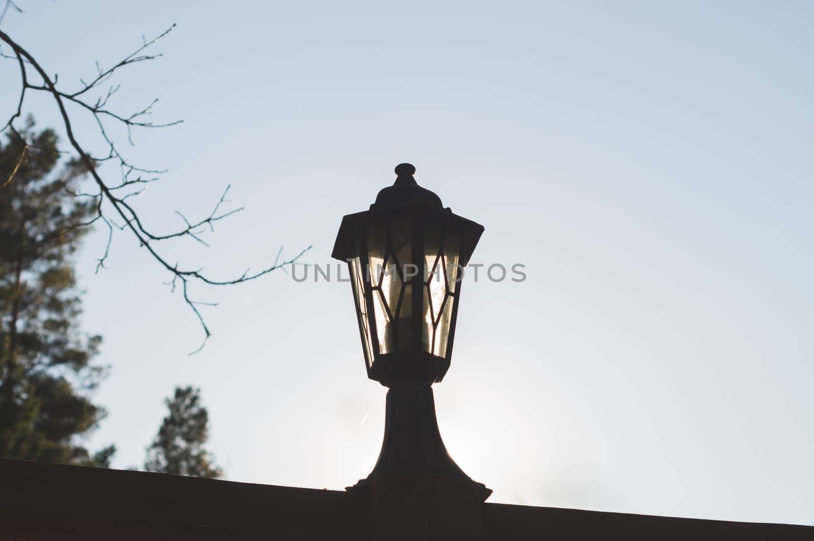 Retro street lamp at sunset. Vintage lantern silhouette. copy space