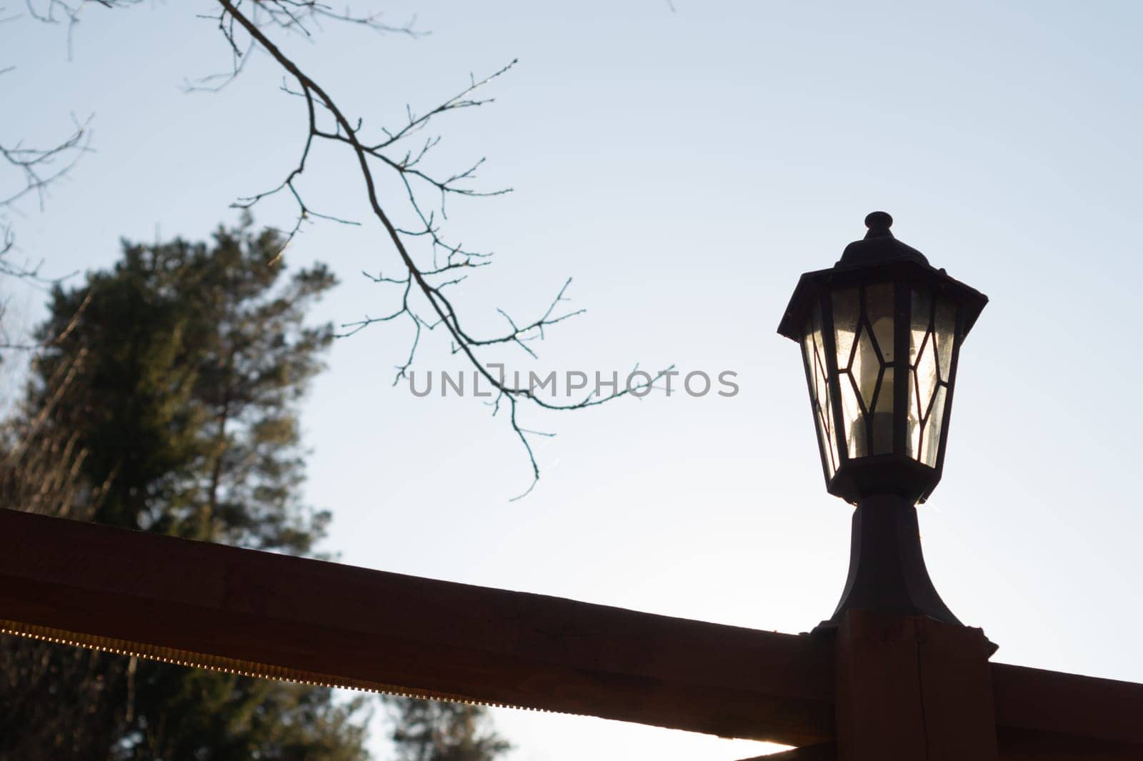 Retro street lamp at sunset. Vintage lantern at evening light background
