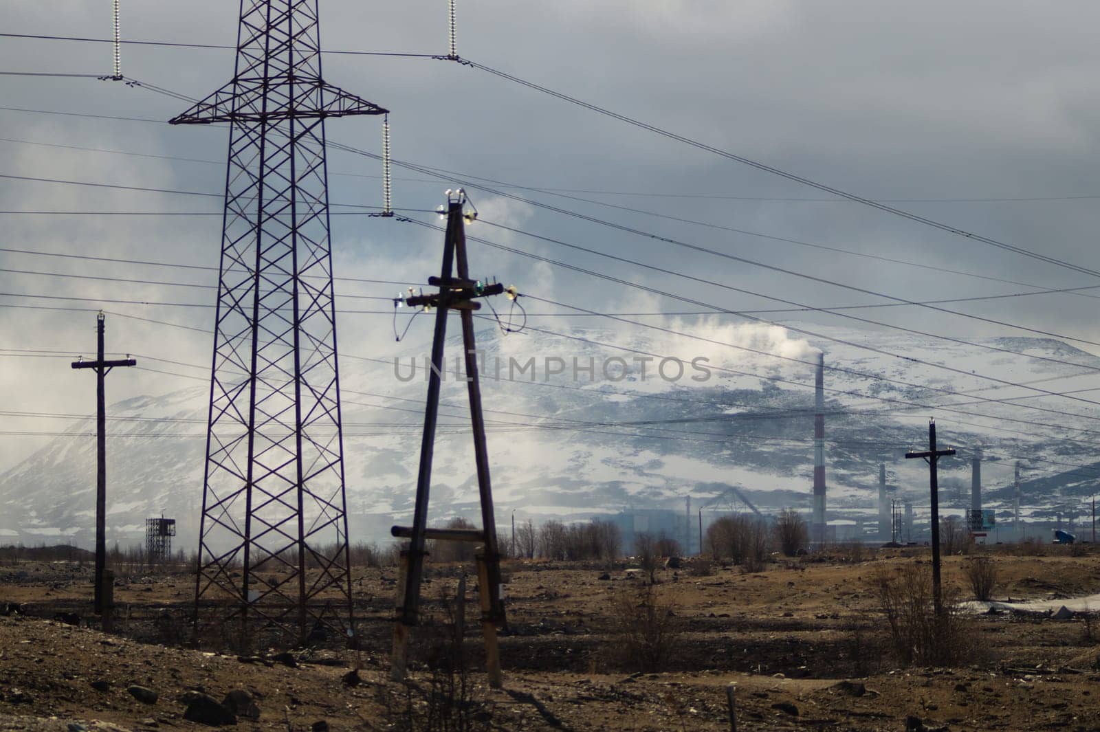 Mountain landscape background. snowy hills and forest. power lines in mountains