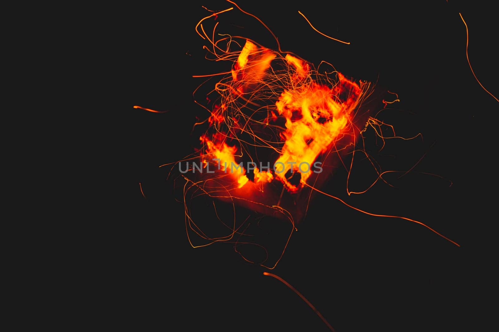 Fire flames with sparks in the dark background. bonfire at night