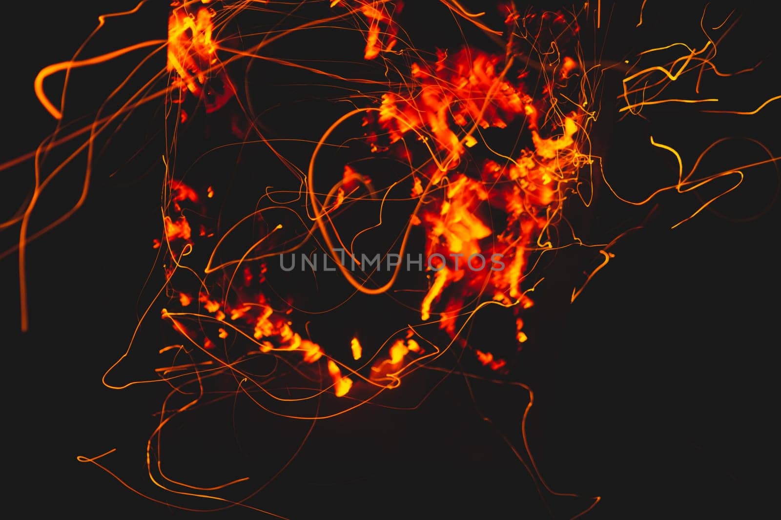 Fire flames with sparks in the dark background. bonfire at night
