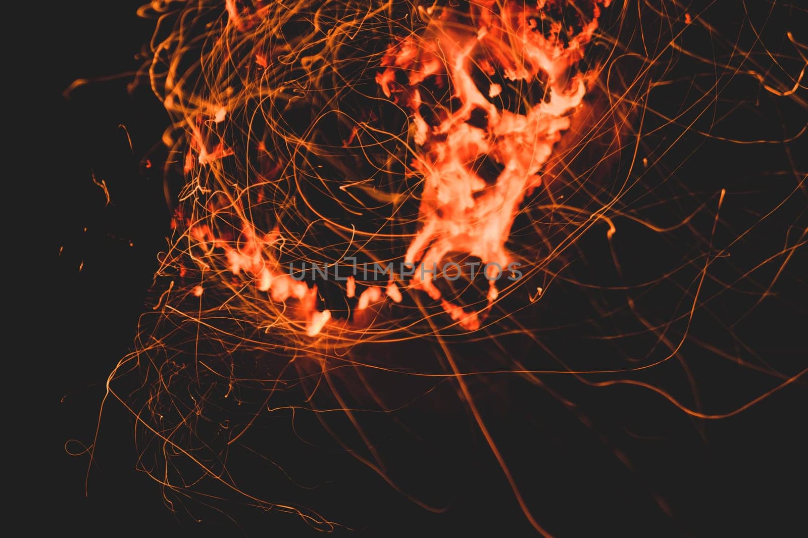 Fire flames with sparks in the dark background. bonfire at night