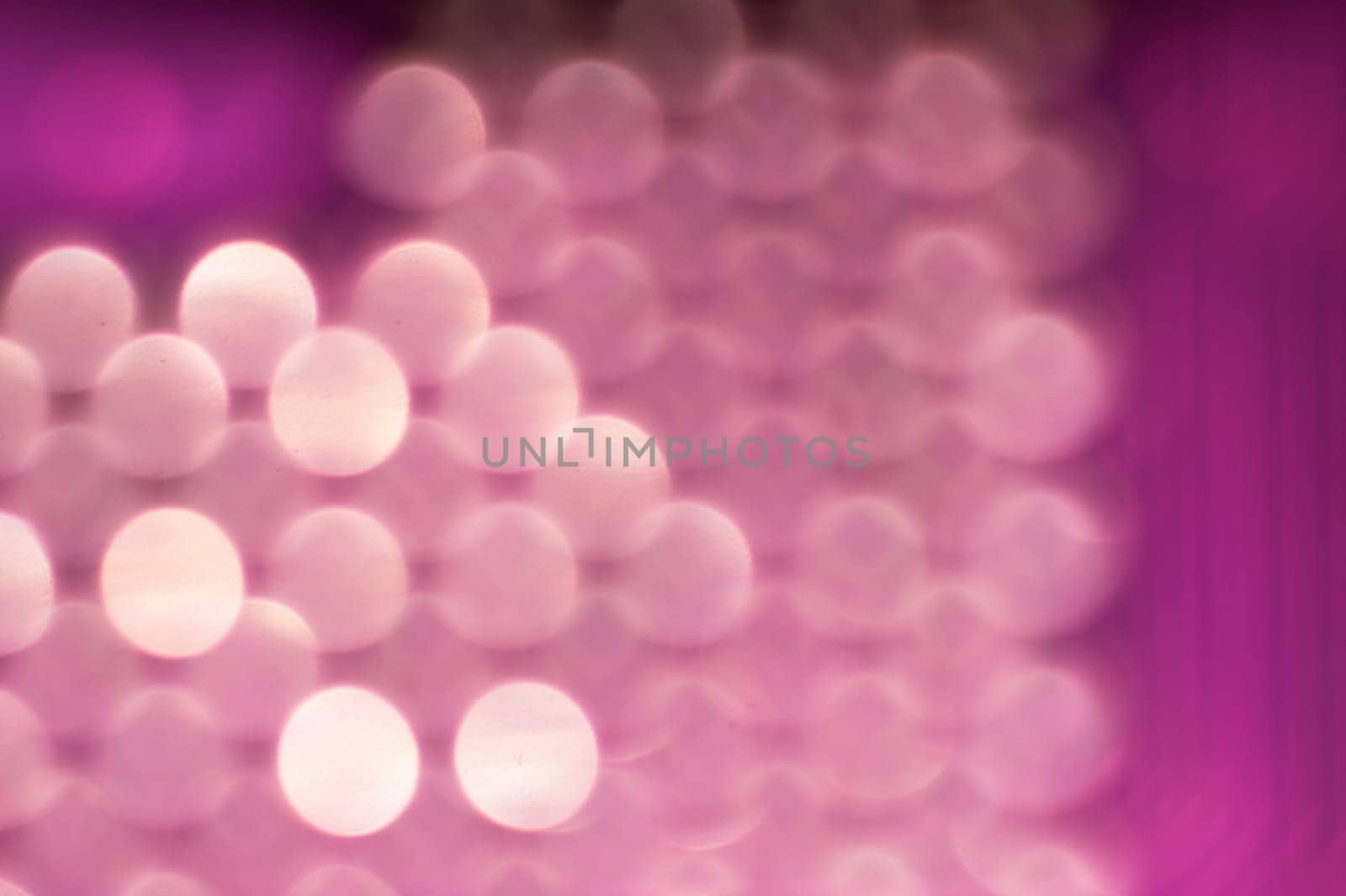 Abstract colorful bokeh defocused lights in pattern of straight rows. holiday background