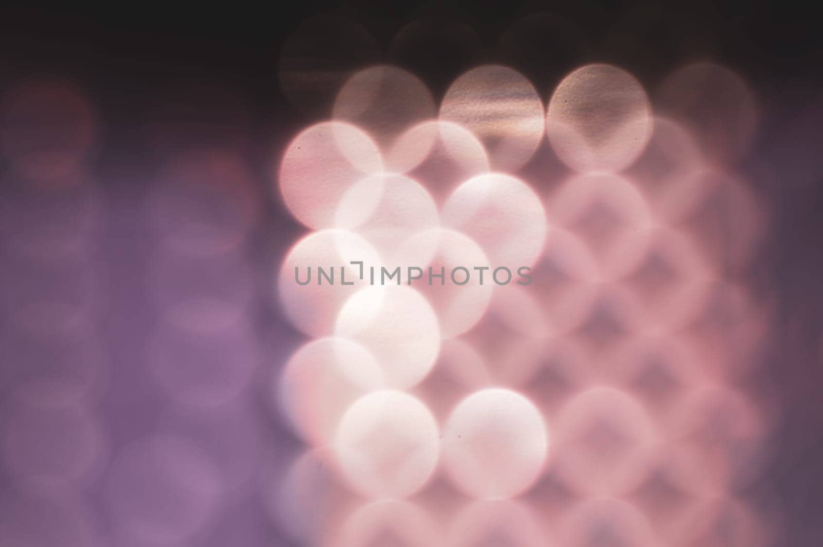 Abstract colorful bokeh defocused lights in pattern of straight rows. holiday background