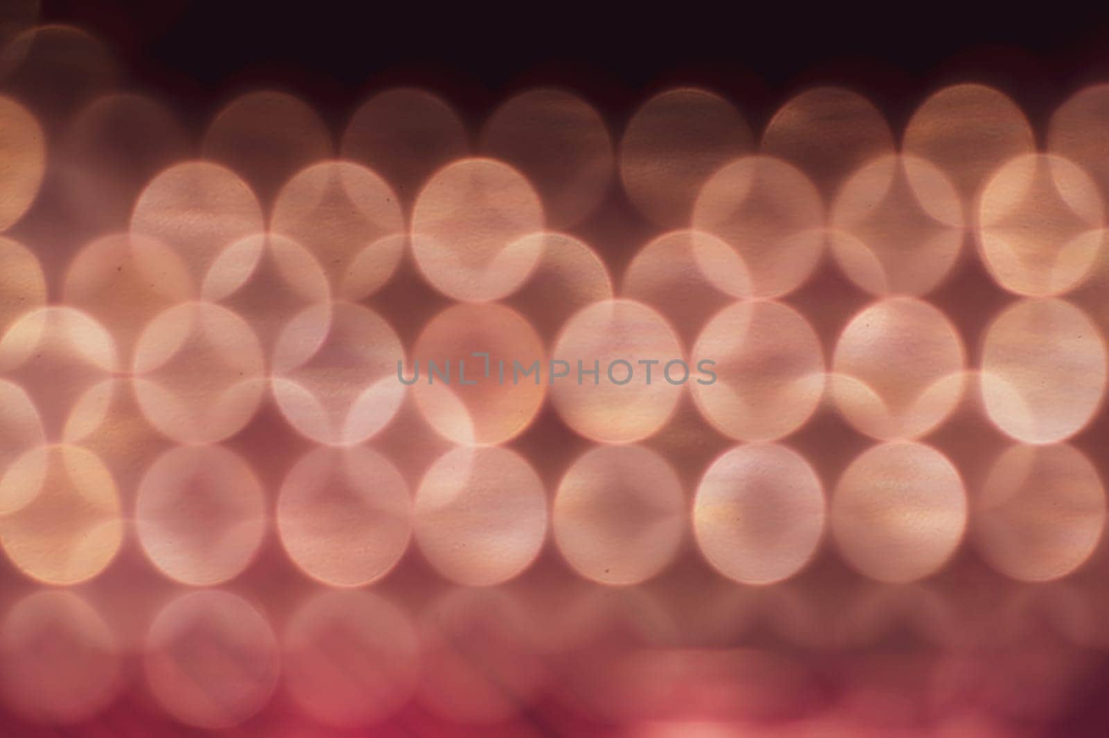 Abstract colorful bokeh defocused lights in pattern of straight rows. holiday background