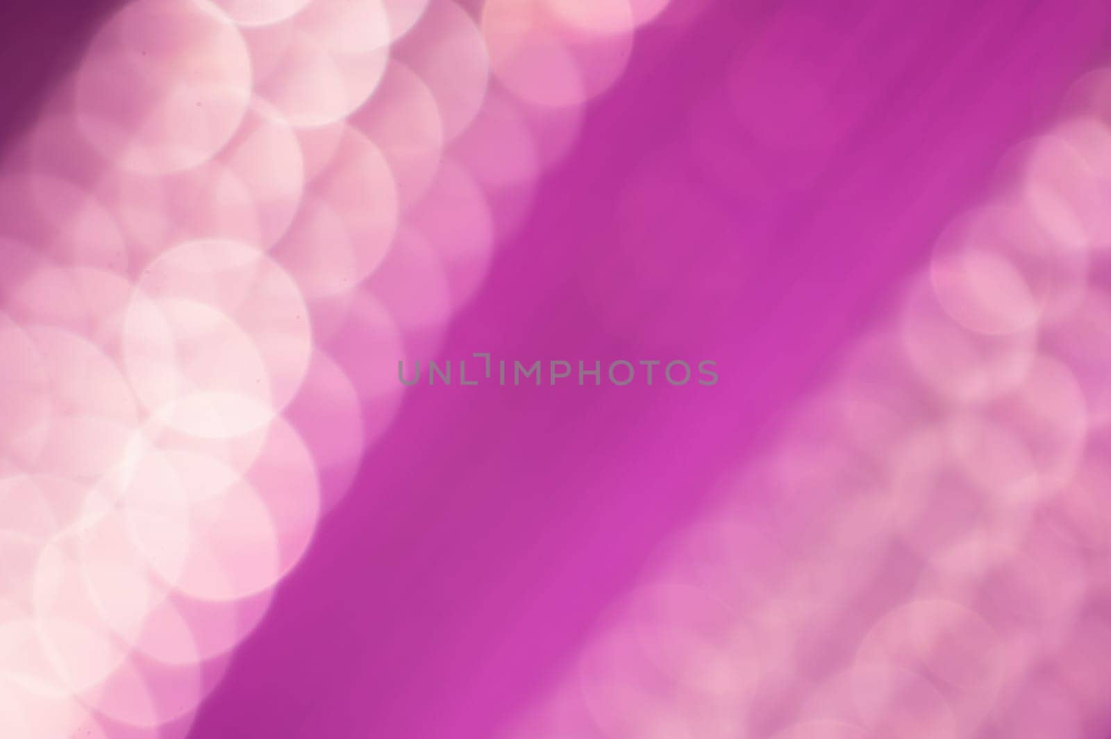 Abstract colorful bokeh defocused lights in pattern of straight rows. holiday background