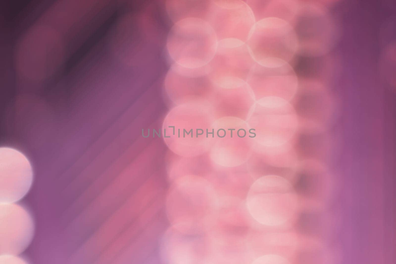 Abstract colorful bokeh defocused lights in pattern of straight rows. holiday background