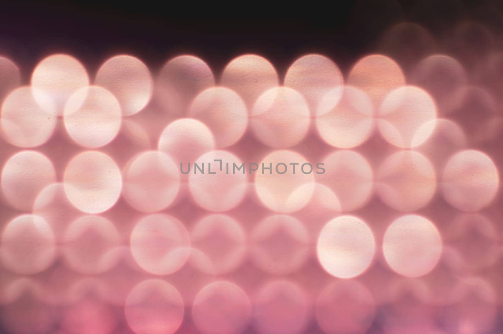 Abstract colorful bokeh defocused lights in pattern of straight rows. holiday background