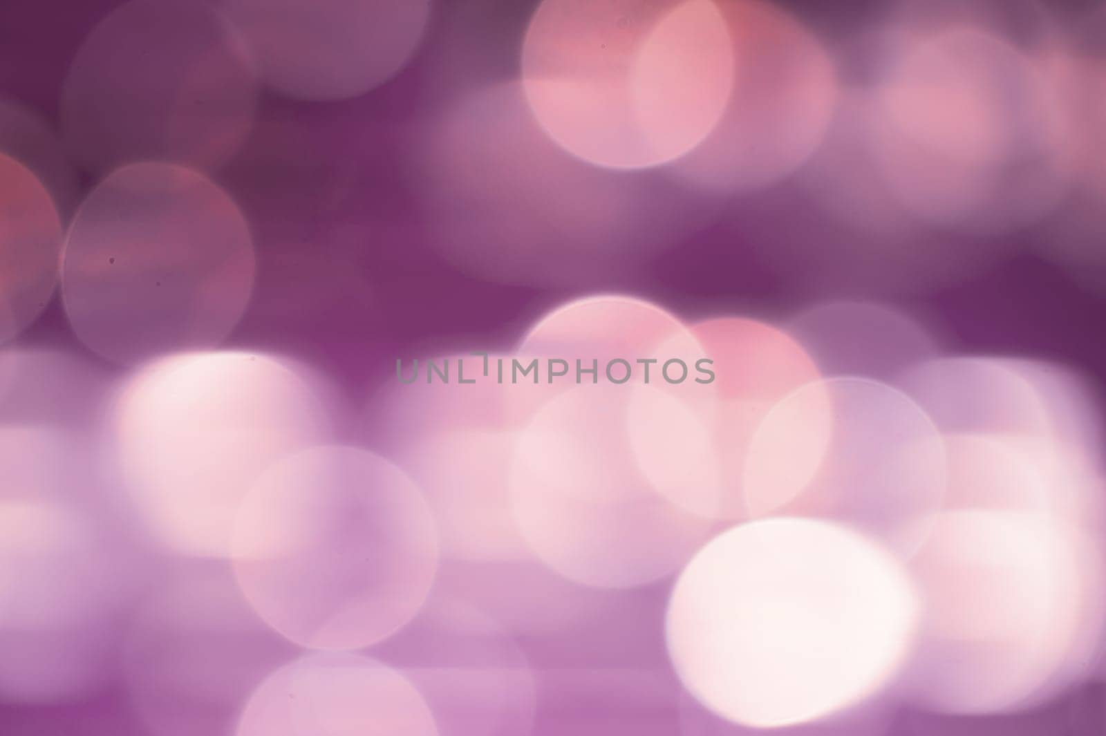 Abstract colorful bokeh defocused lights in pattern of straight rows. holiday background