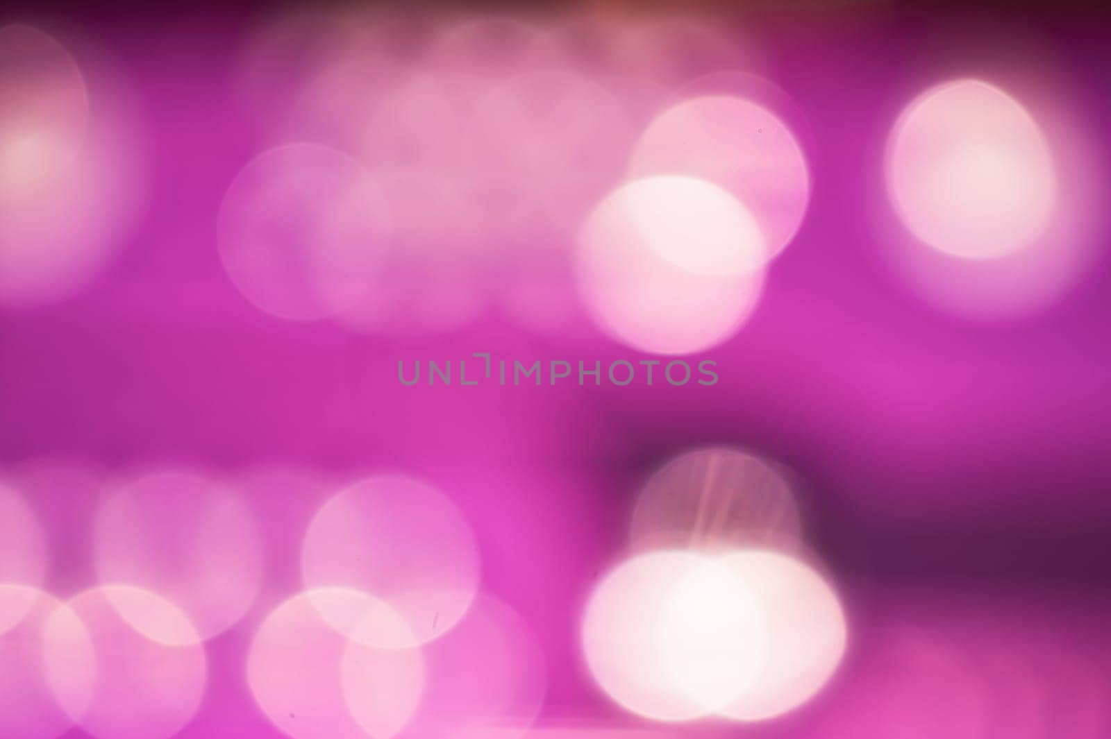 Abstract colorful bokeh defocused lights in pattern of straight rows. holiday background