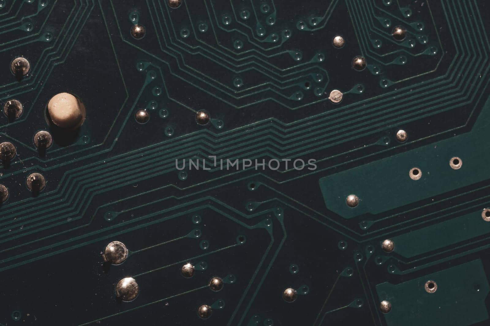 Dusty circuit board. computer motherboard close up. modern technologies. micro elements of computer with connections and traces. Intelligent technology abstract background