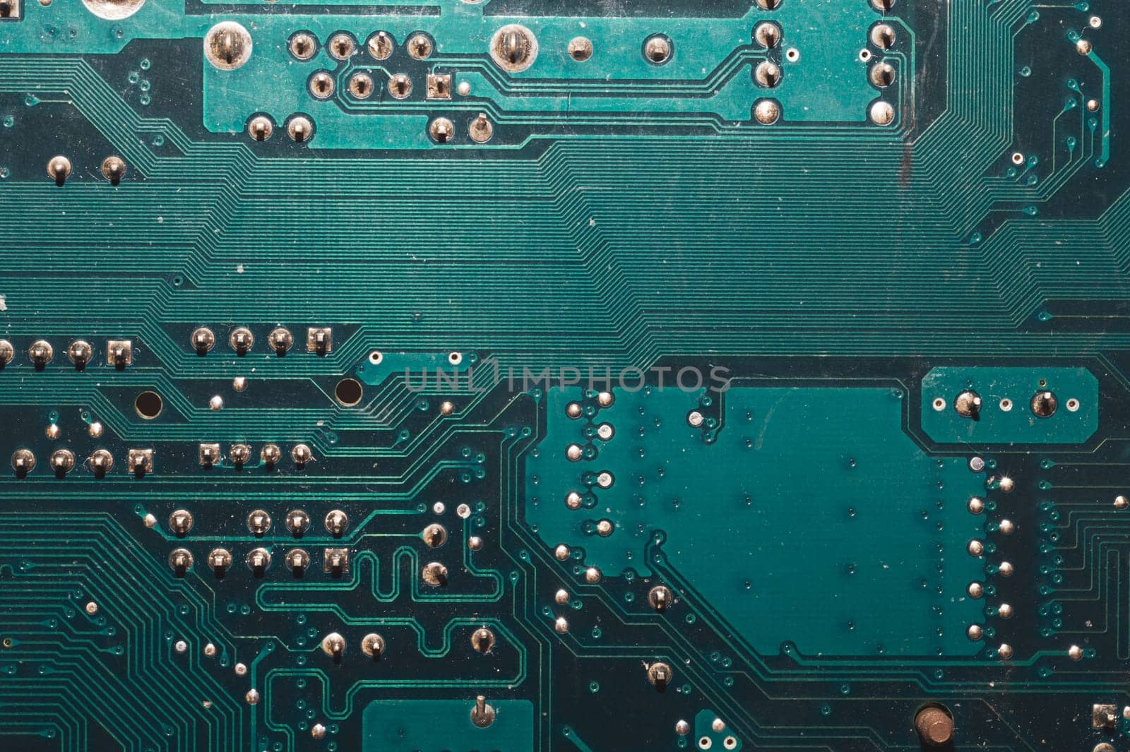 Dusty circuit board. computer motherboard close up. modern technologies. micro elements of computer with connections and traces. Intelligent technology abstract background