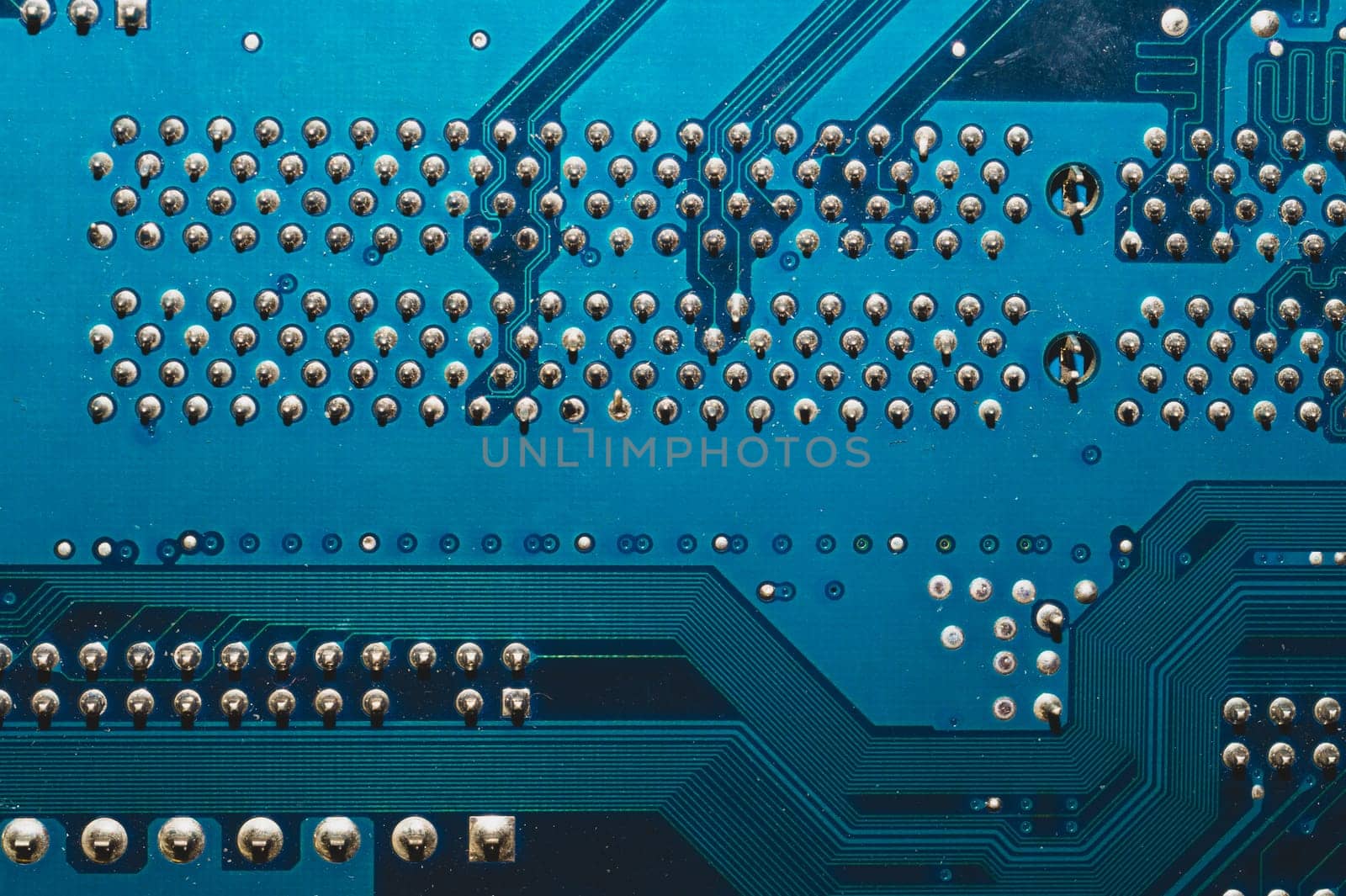 Dusty circuit board. computer motherboard close up. modern technologies. micro elements of computer with connections and traces. Intelligent technology abstract background