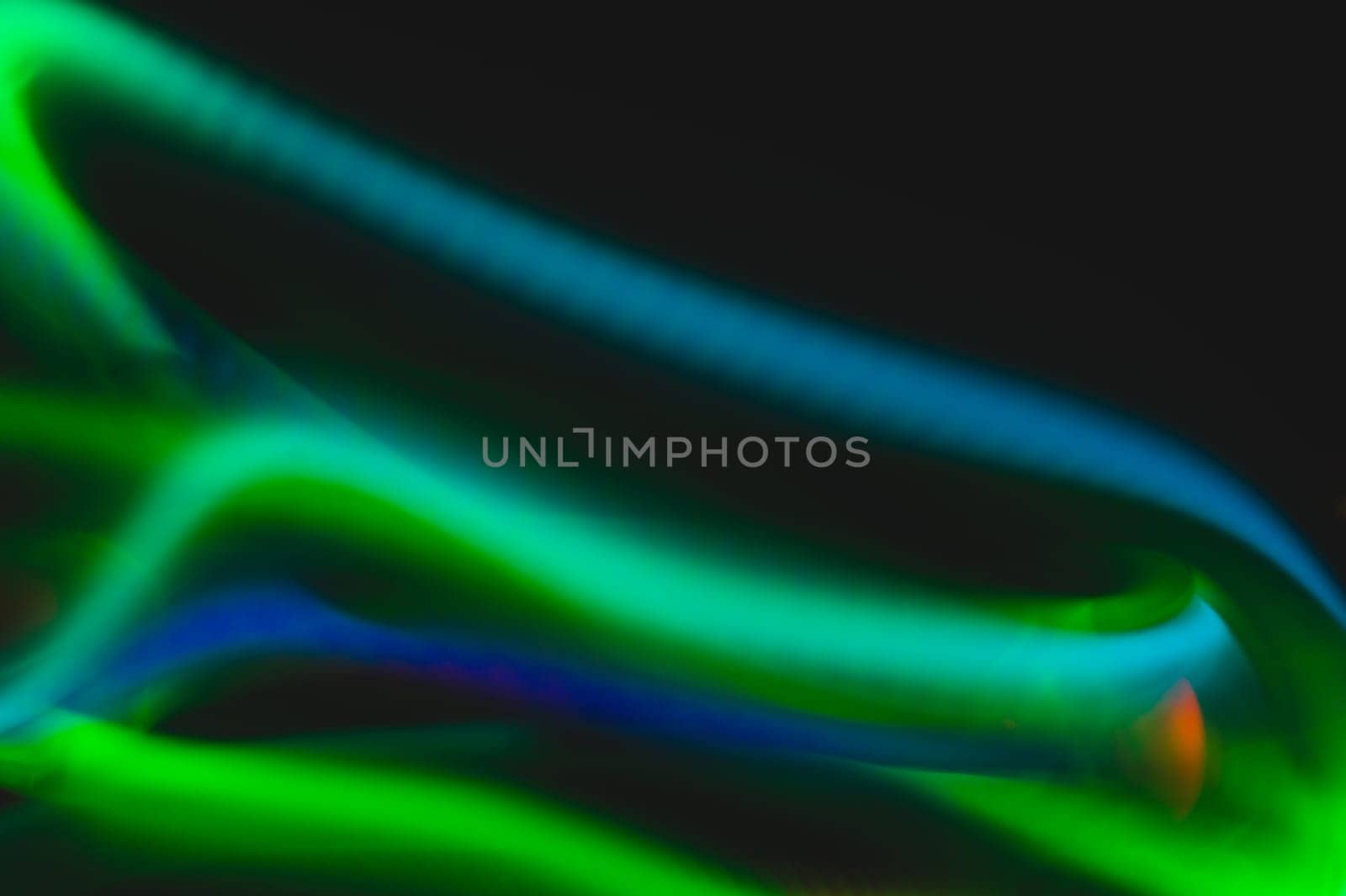 Colorful light traces with long exposure in the dark. abstract blurred lights background