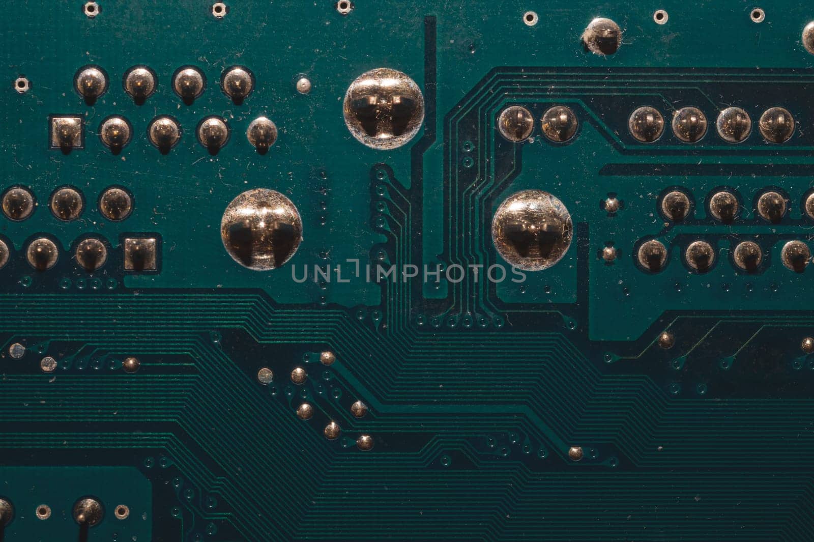 Dusty circuit board. computer motherboard close up. modern technologies. micro elements of computer with connections and traces. Intelligent technology abstract background