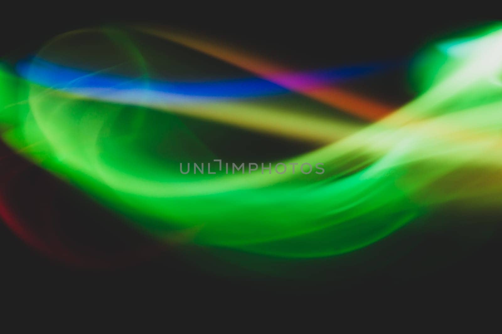 Colorful light traces with long exposure in the dark. abstract blurred lights background