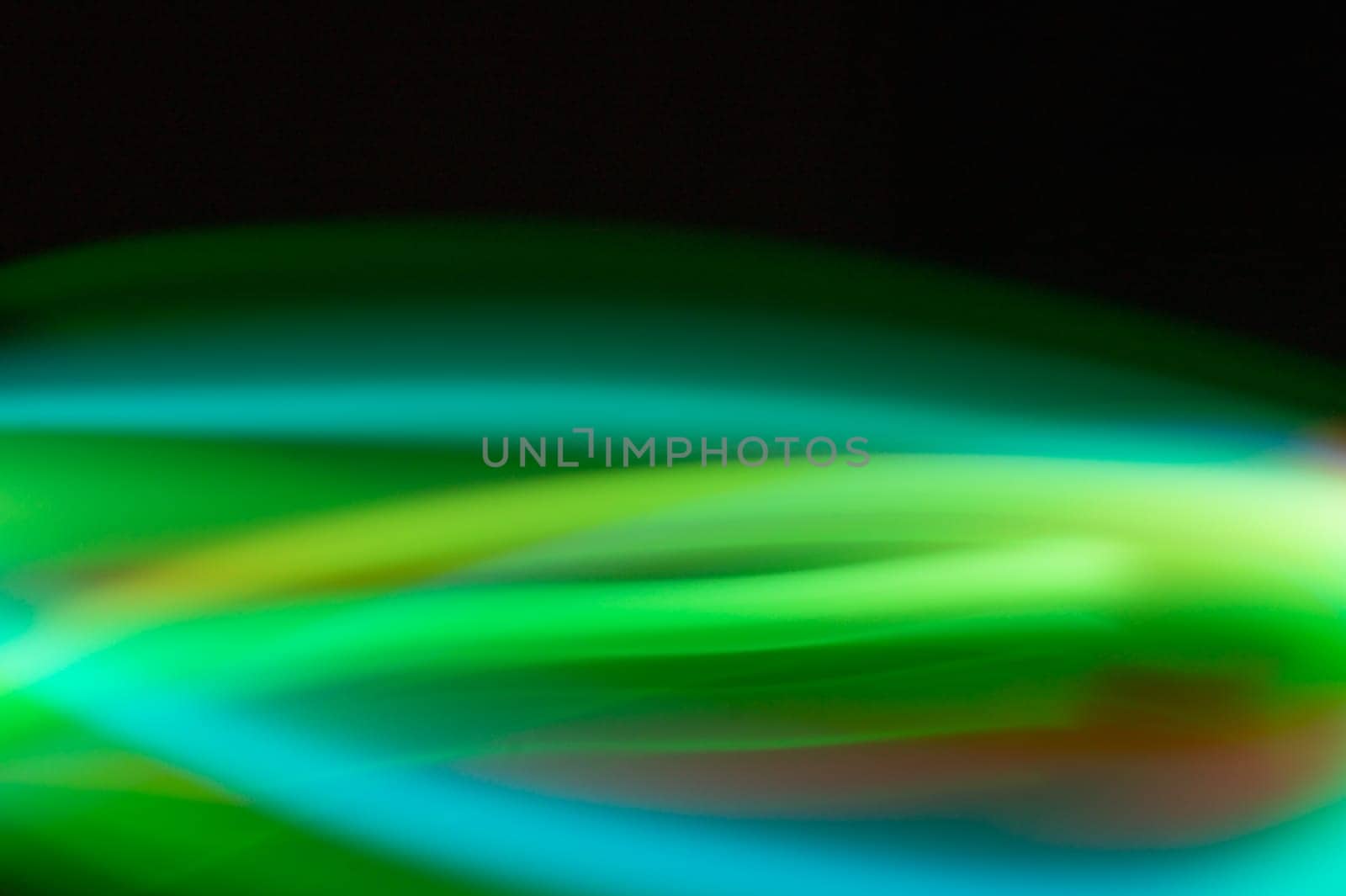 Colorful light traces with long exposure in the dark. abstract blurred lights background