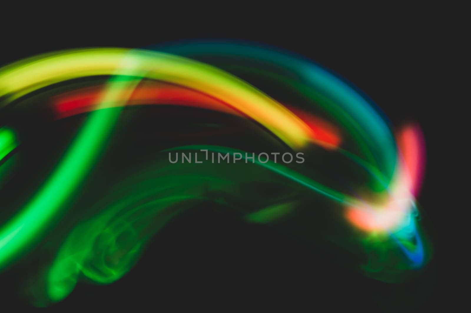 Colorful light traces with long exposure in the dark. abstract blurred lights background