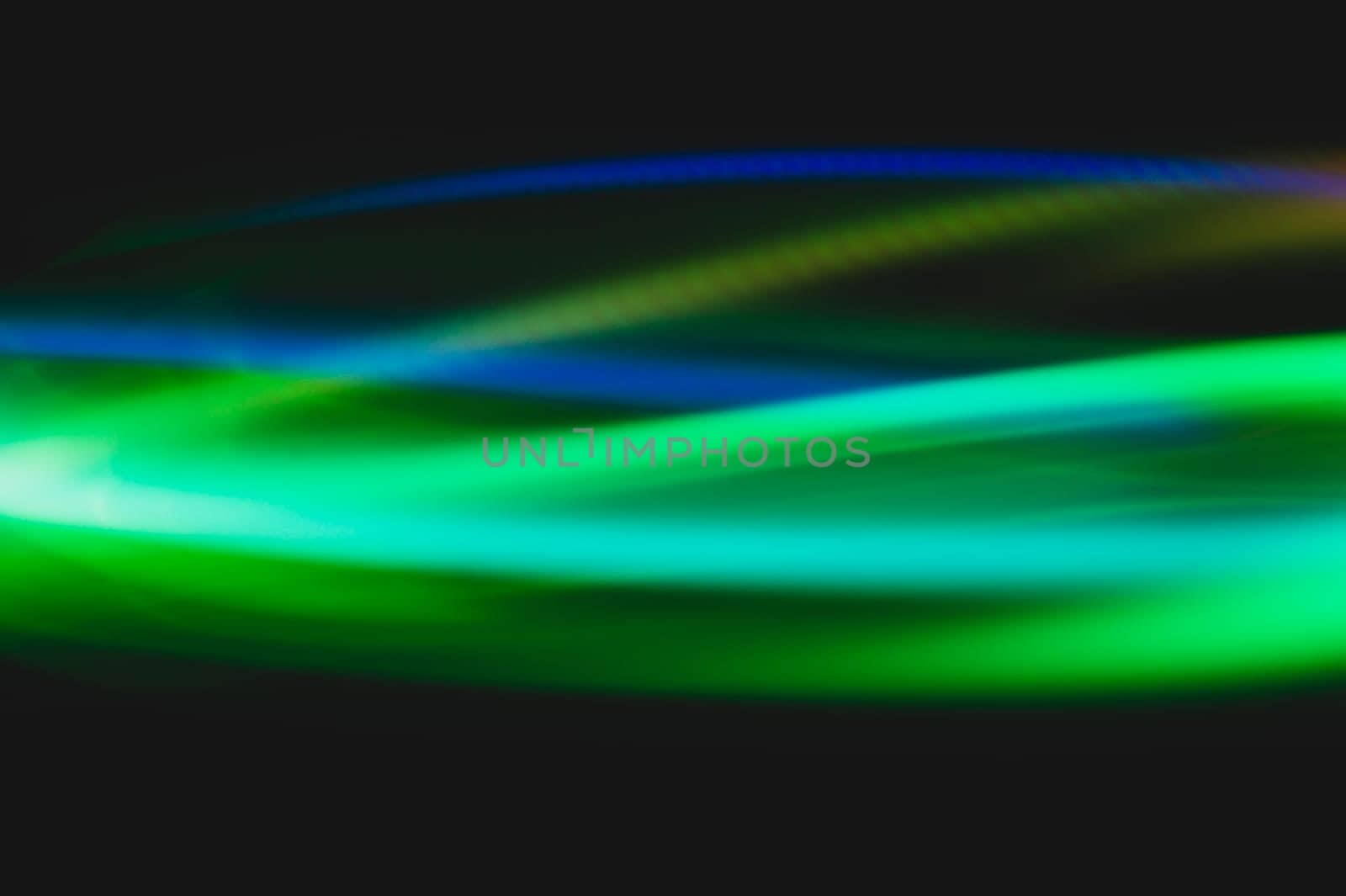 Colorful light traces with long exposure in the dark. abstract blurred lights background