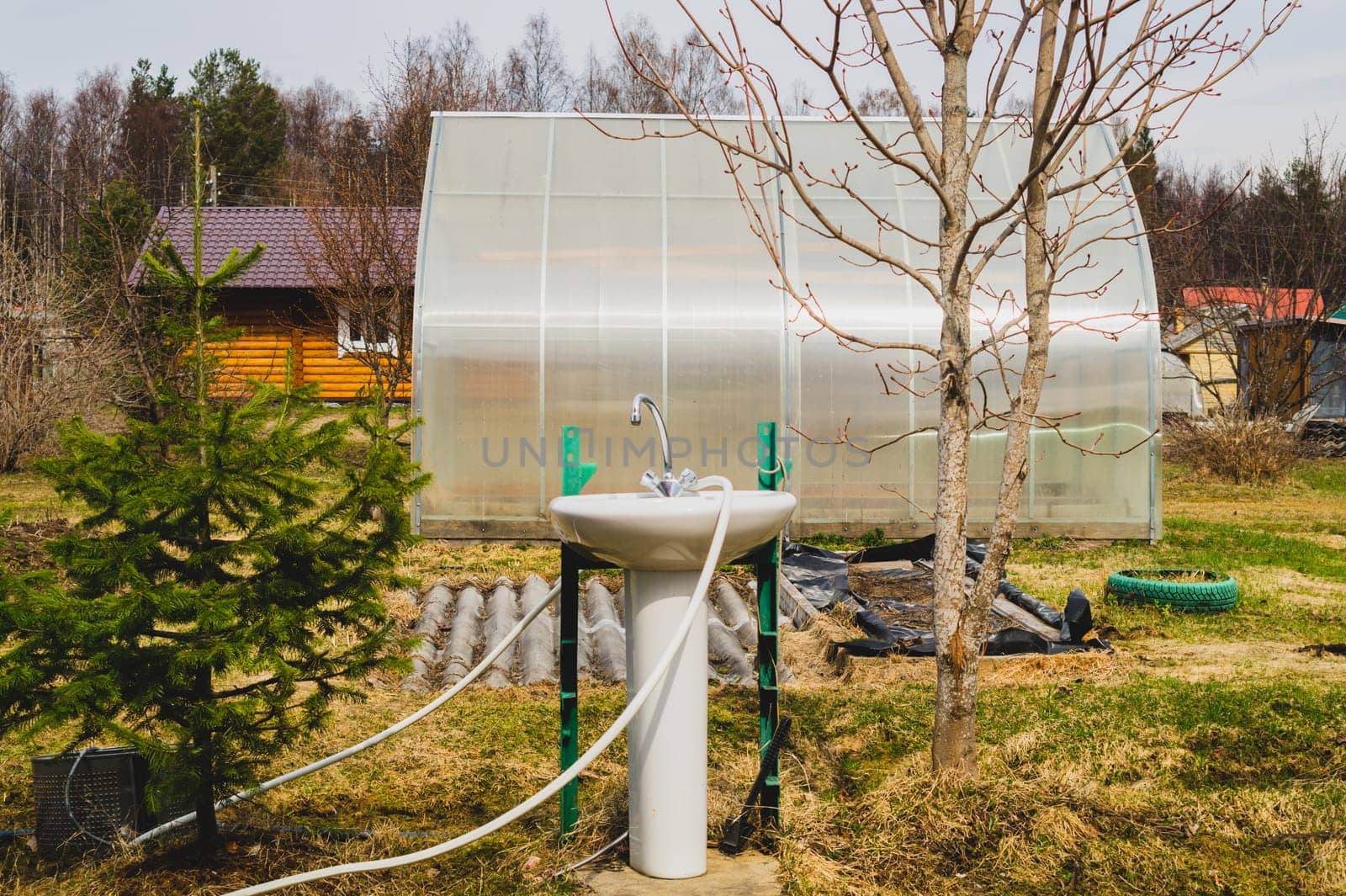 Sink and faucet in the garden. water tap outside the house. backyard of the summer house. closer to nature concept