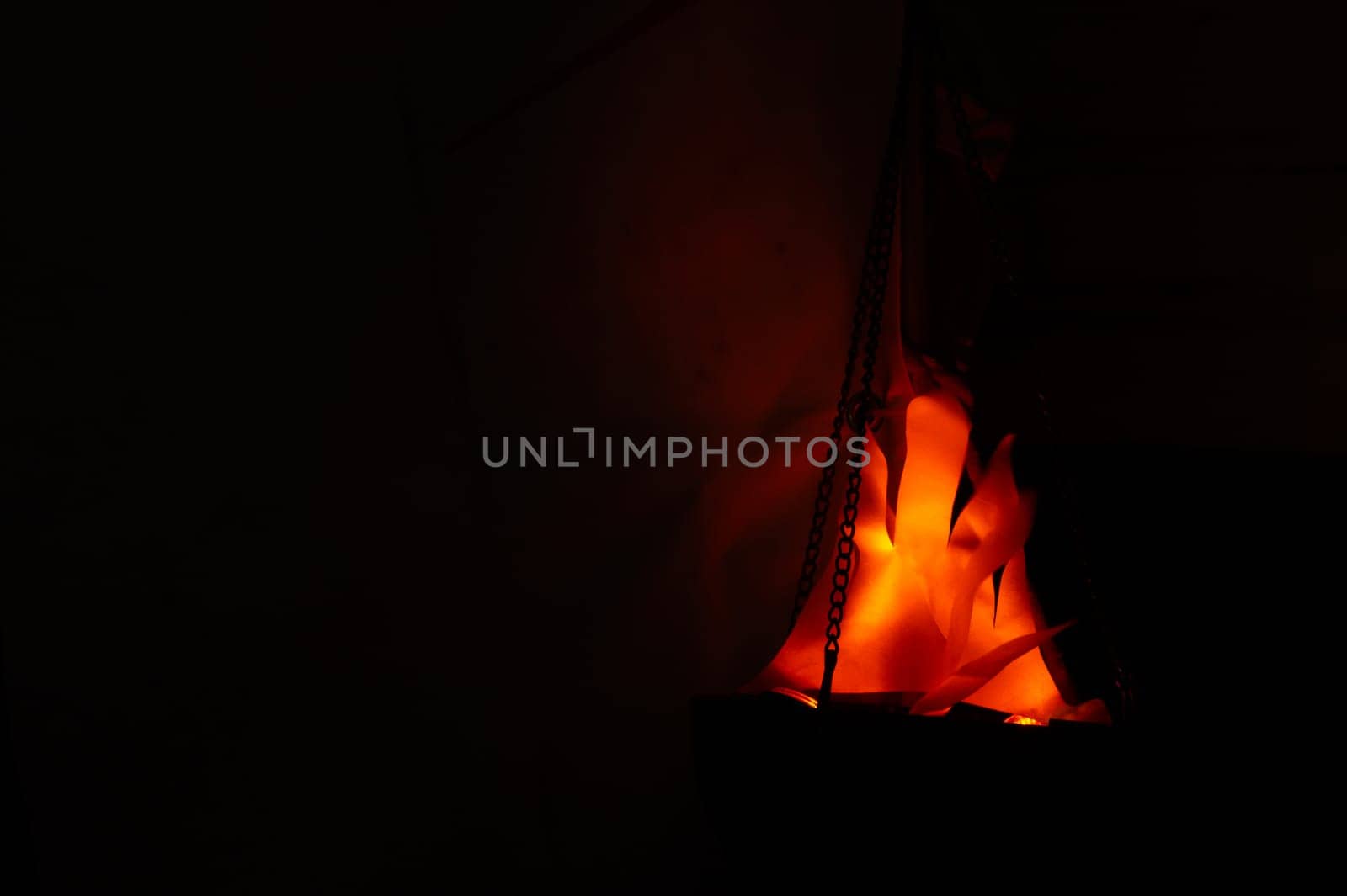Decorative flame in the dark. hanging lantern at night