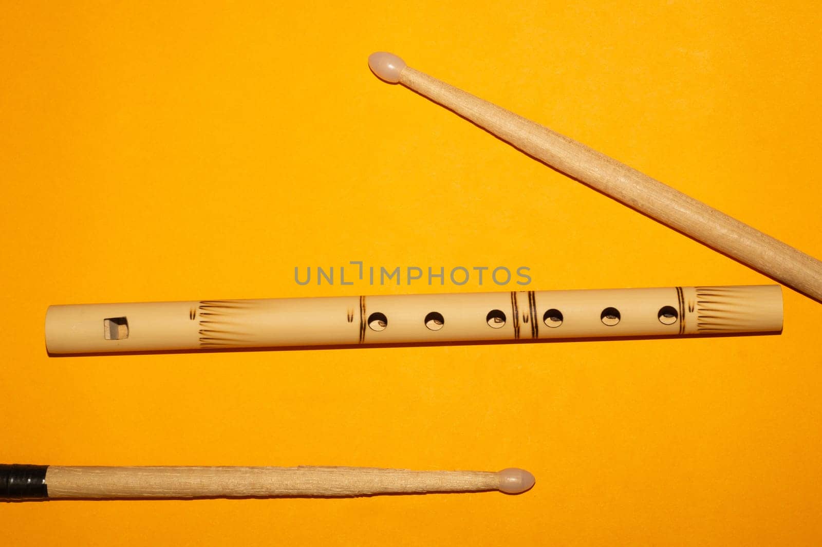 Bamboo bansuri flute and drumsticks. simple music instruments