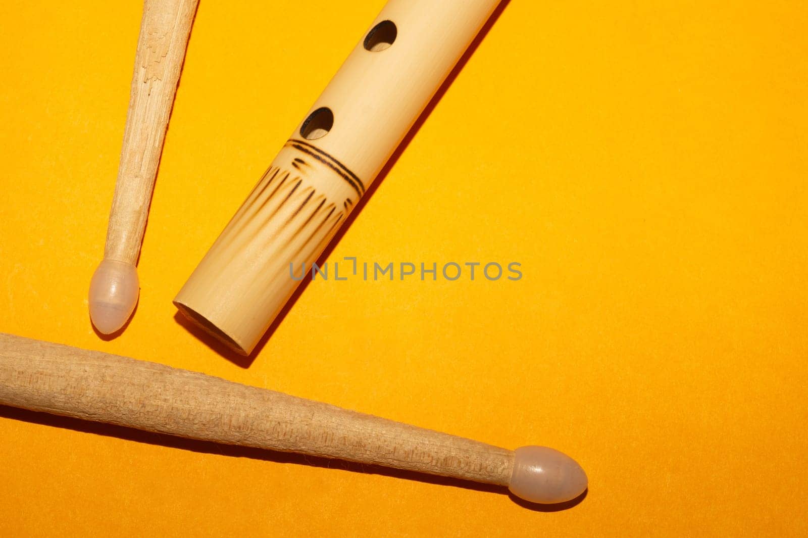 Bamboo bansuri flute and drumsticks. simple music instruments