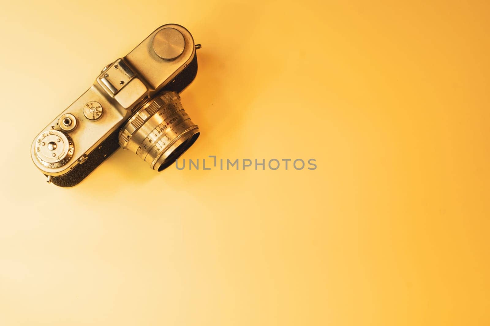 Vintage camera on yellow background. copy space