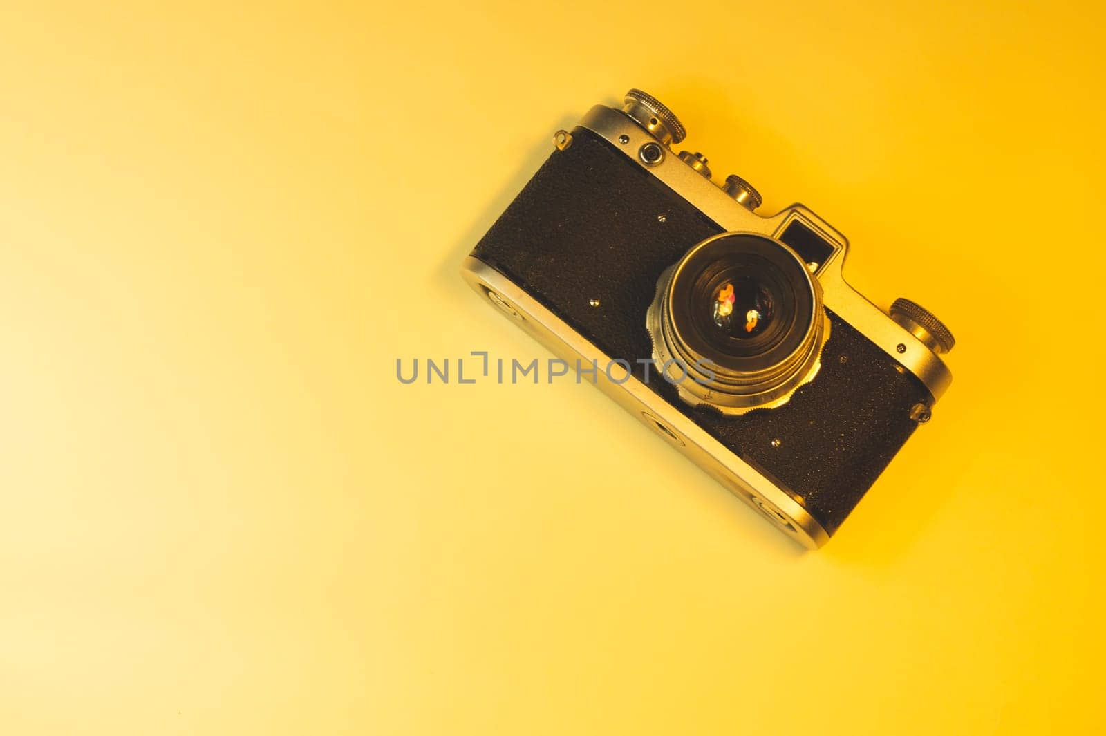 Vintage camera on yellow background. copy space