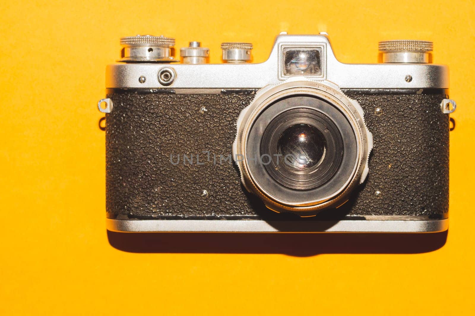 Vintage camera on yellow background. copy space