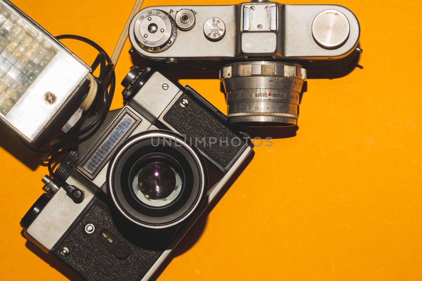 Vintage cameras on yellow background. copy space