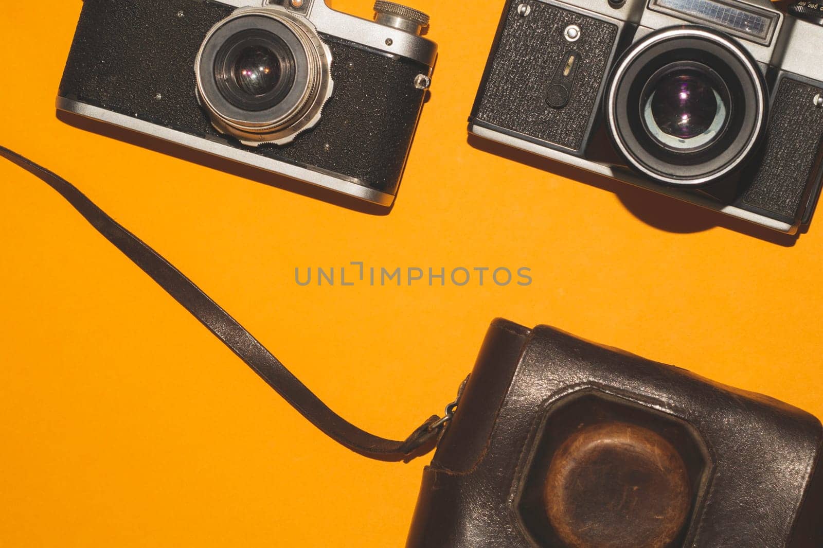 Vintage cameras on yellow background. copy space