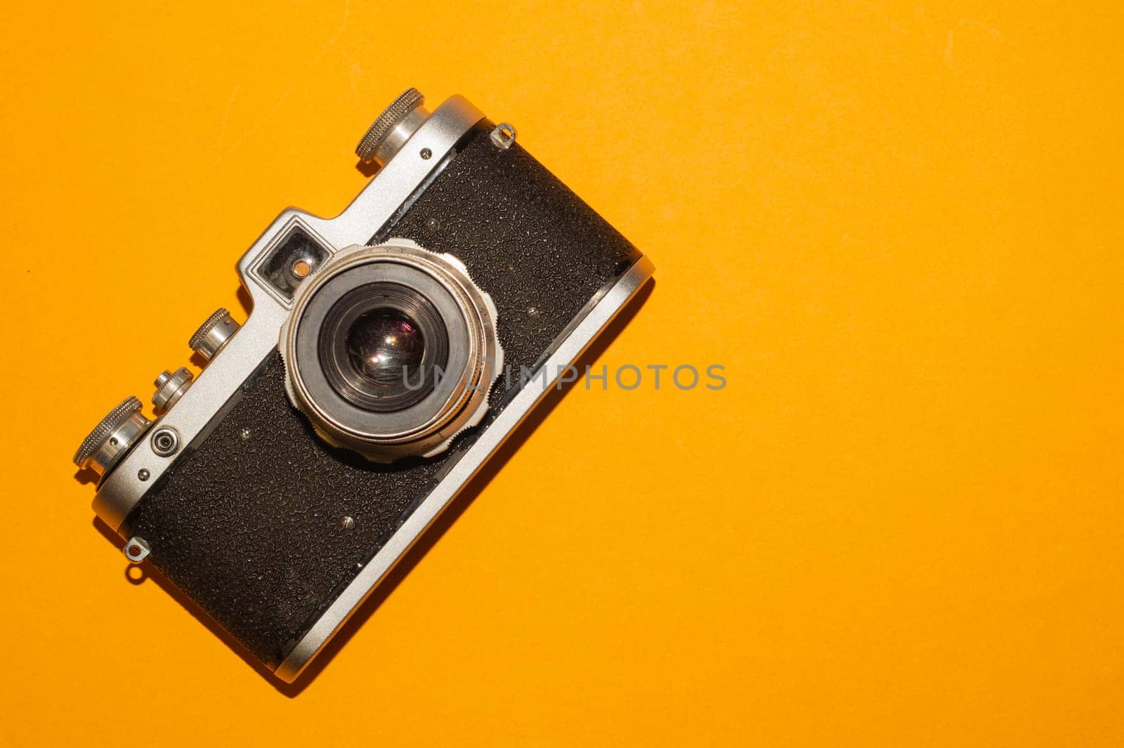 Vintage camera on yellow background. copy space