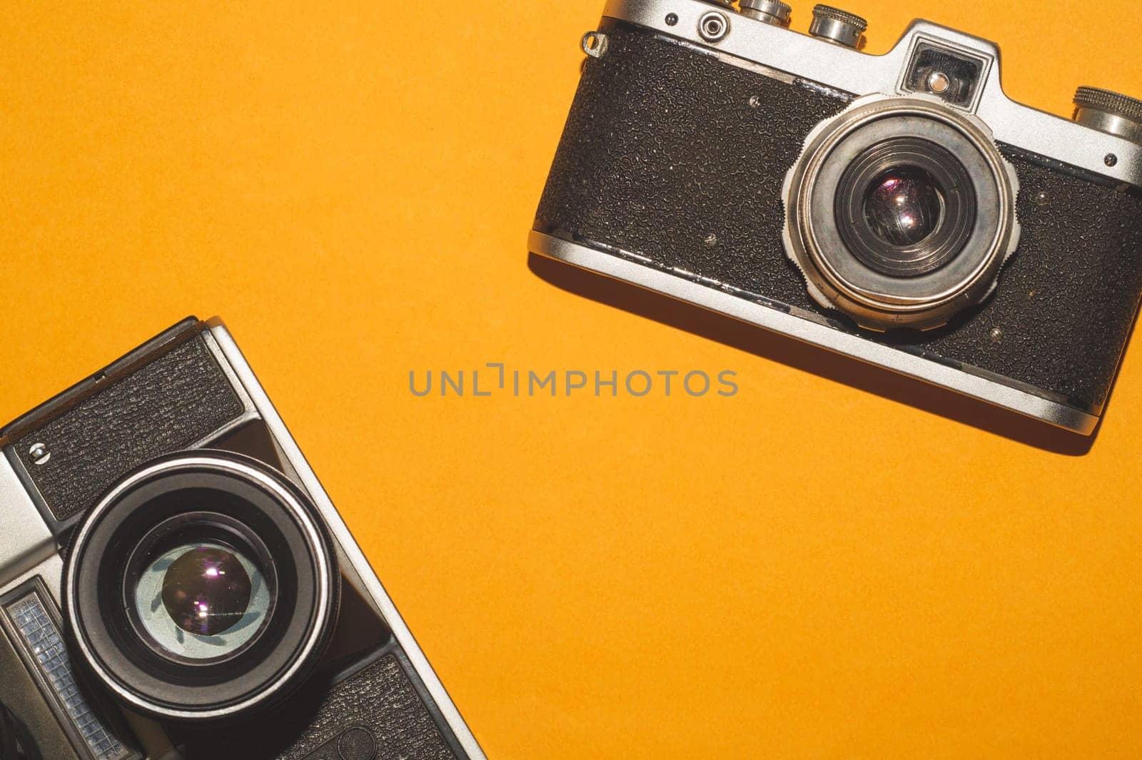 Vintage cameras on yellow background. copy space