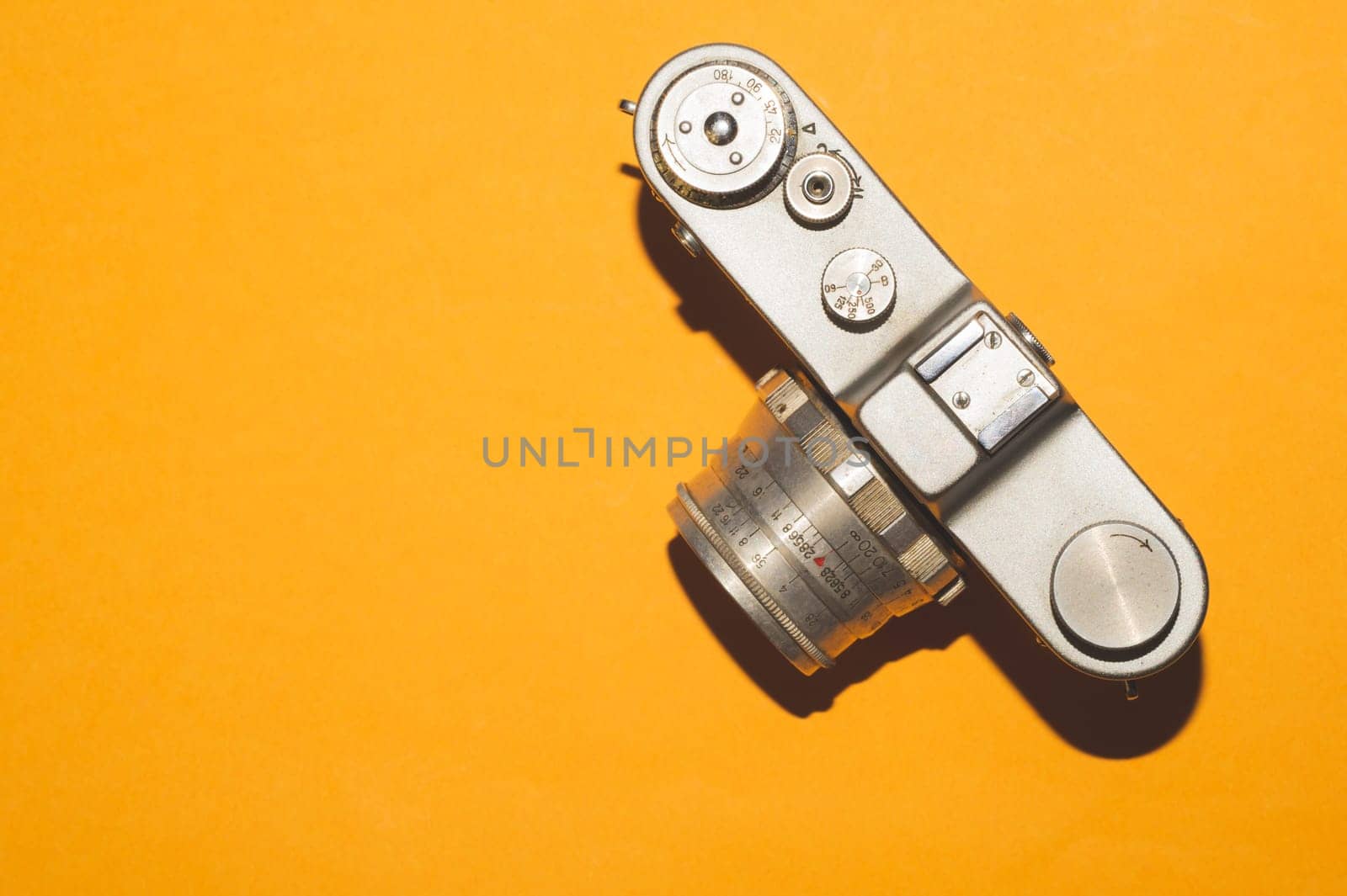 Vintage camera on yellow background. copy space