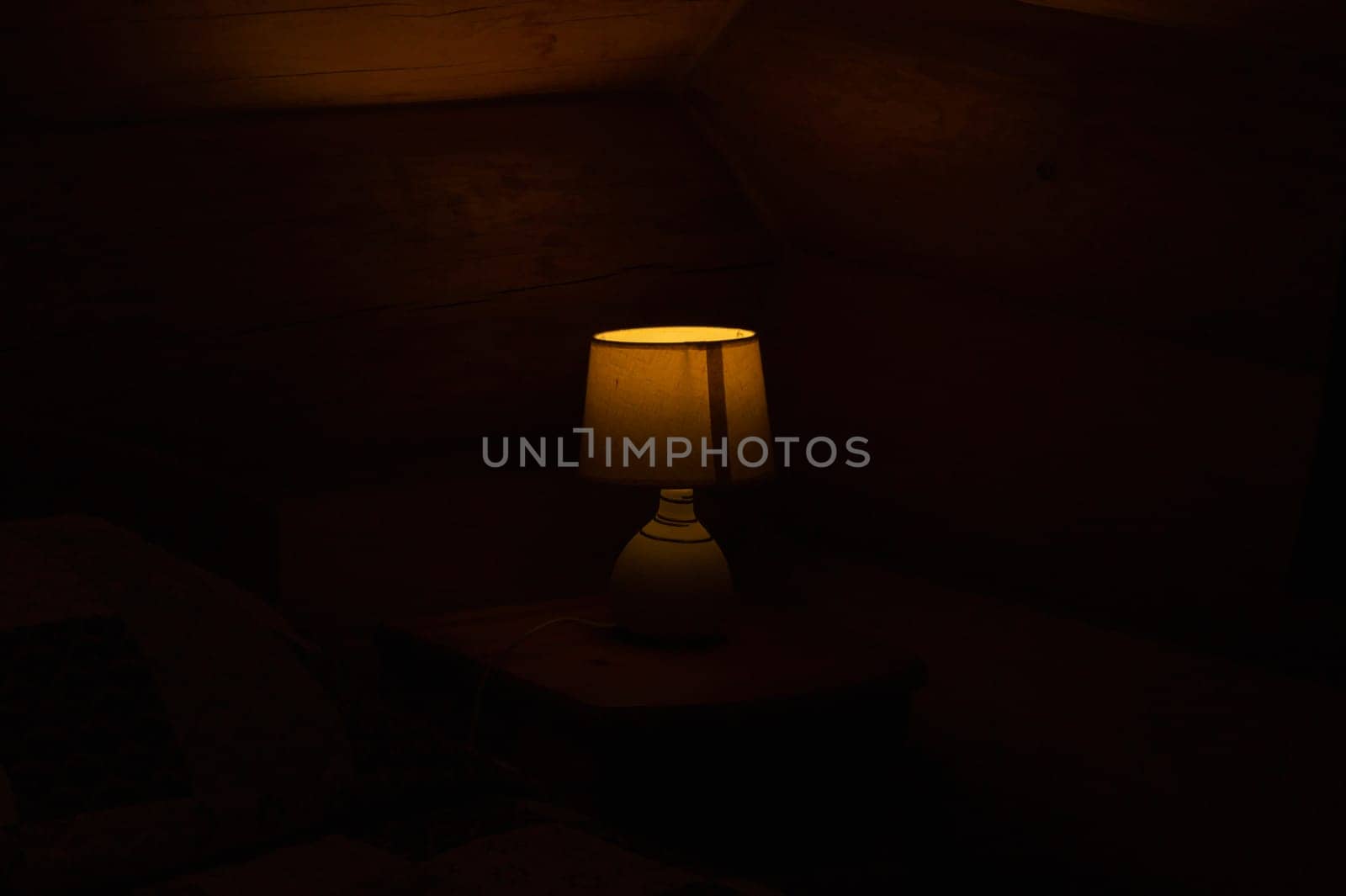Luminous desk lamp with lampshade in the dark